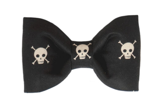 Bold and edgy dog bow tie with skull and crossbones pattern on a sleek black backdrop, perfect for the rebellious pup.
