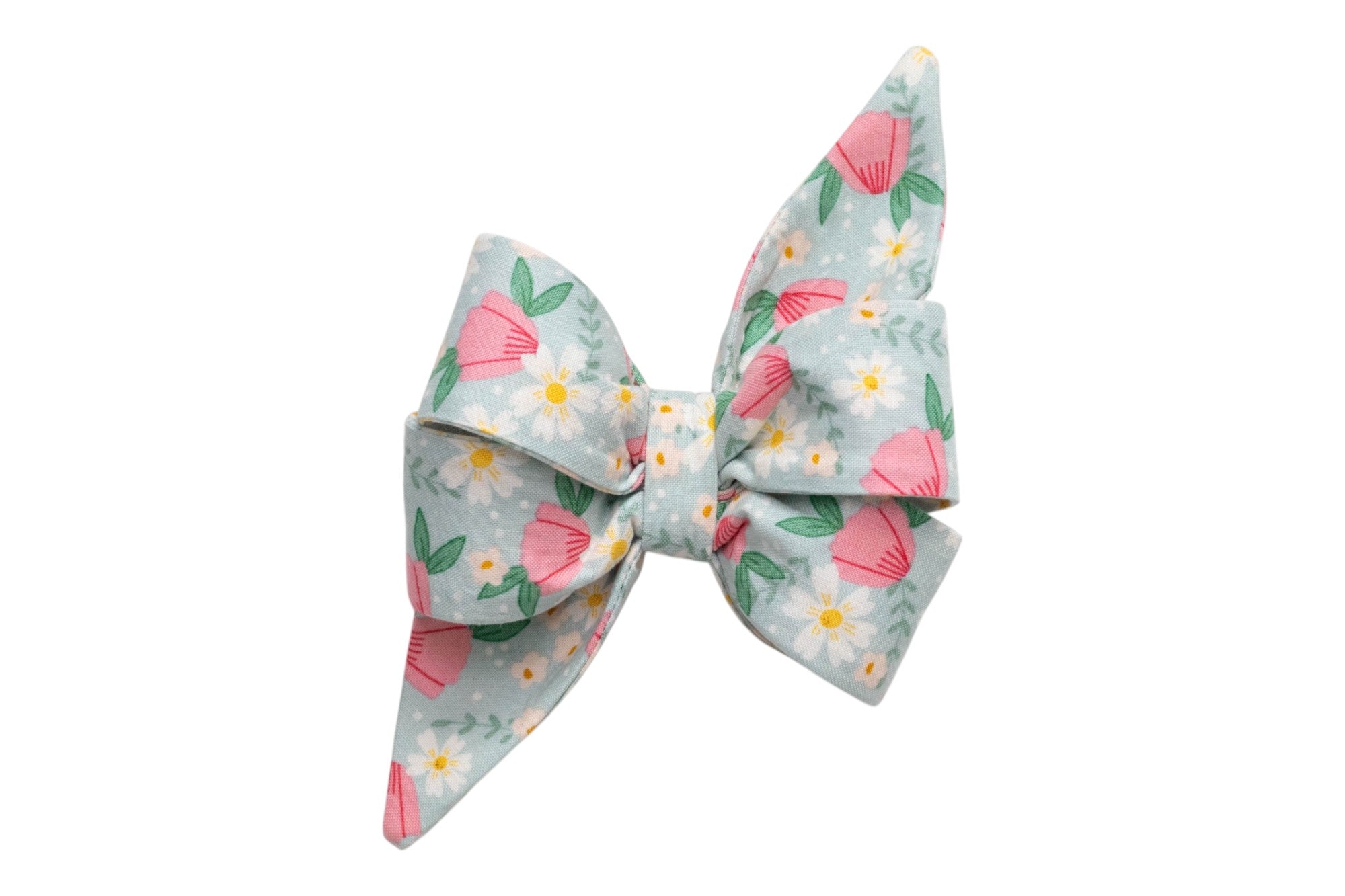 Floral dog bow with pink blossoms, white daisies, and green leaves on a pastel blue background for a fresh spring look.