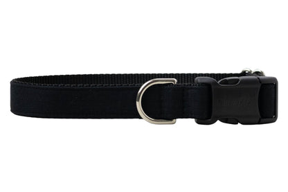 A solid black adjustable dog collar made of durable nylon webbing with reinforced stitching. The collar features a matte black plastic side-release buckle, a metal D-ring and a subtle, sleek design.