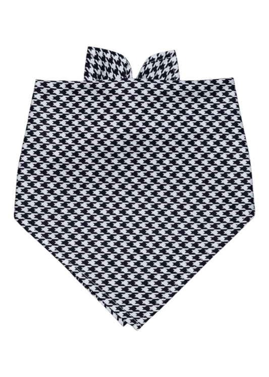 Classic dog bandana in a bold black and white houndstooth print, tied in a traditional triangle shape. The fabric appears smooth and lightweight, making it a comfortable and stylish accessory for pets with a preppy or elegant wardrobe.
