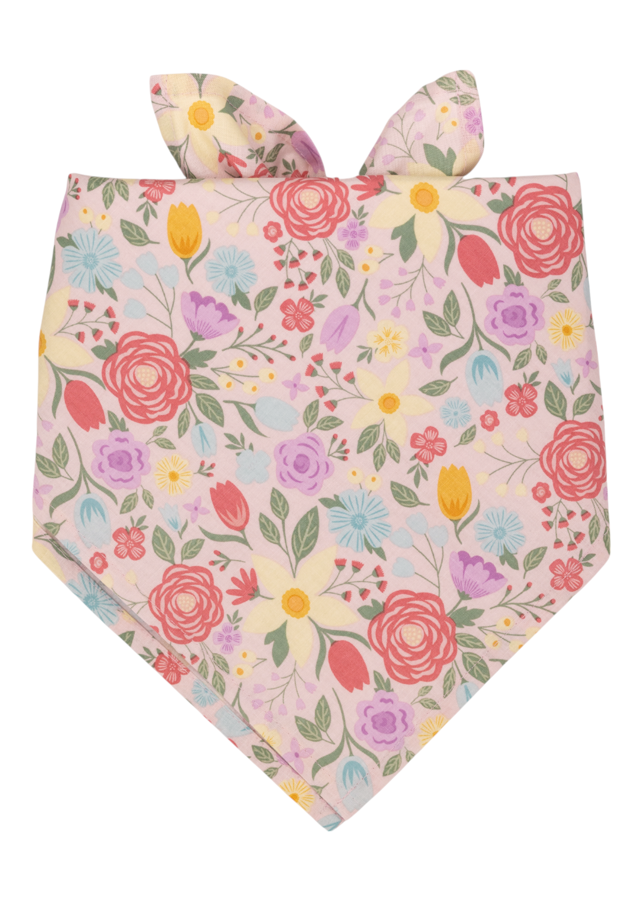 Colorful floral bandana in soft pink fabric, featuring an array of blooming flowers in bright spring shades and leafy green stems. The top is tied into two pointed, bunny ear-style knots.