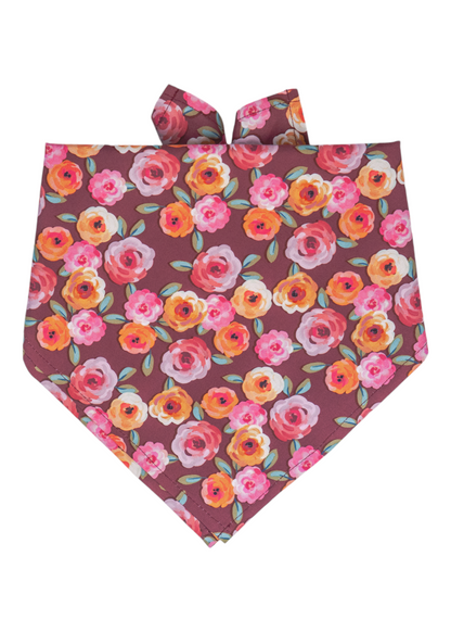 Dog bandana with a playful fall floral design, featuring hand-painted-style roses inin warm tones on a burgundy base. The bandana is folded in a classic triangle and made to tie around your pups neck.