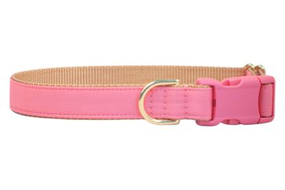 A high-quality bubblegum pink dog collar with tan webbing and reinforced stitching, showcasing pink plastic buckle engraved with the brand “Crewlala” and a gold D-ring, blending comfort, charm, and durability for your stylish pup.