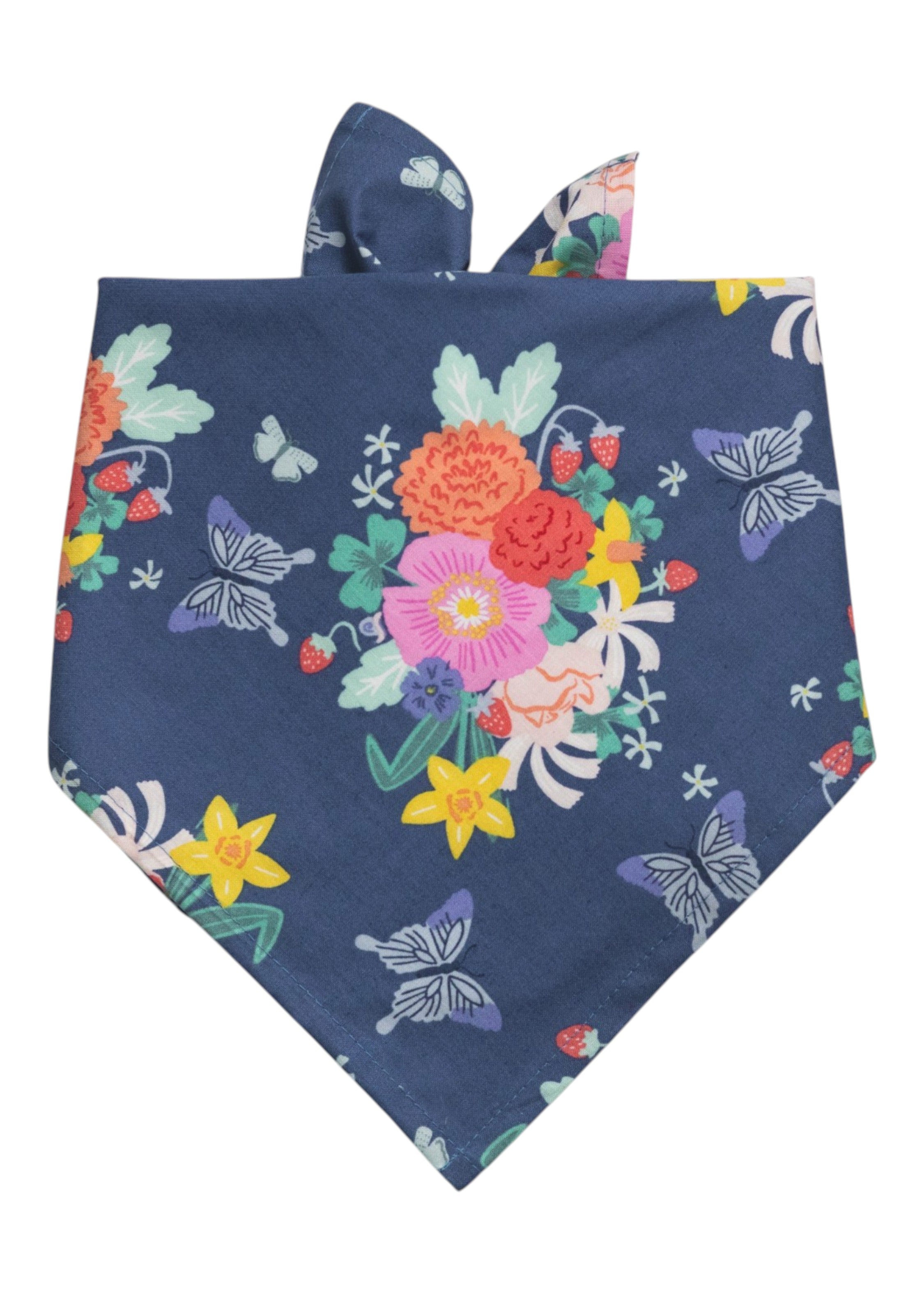 Navy blue dog bandana with a colorful floral bouquet, butterflies, and small strawberries, folded into a triangle with tie ends.