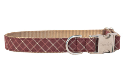 Burgundy dog collar with a light plaid design, complemented by a shiny metal buckle engraved with “Crewlala” and a matching D-ring for leash or tag attachment.