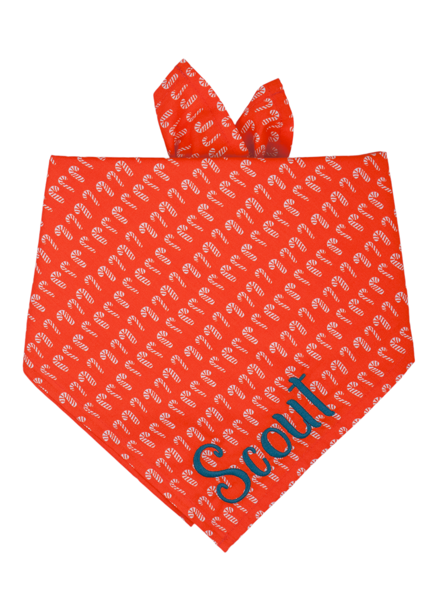 Christmas-themed dog bandana made from red fabric covered in a pattern of miniature candy cane illustrations. The bandana is folded like an inverted triangle and includes a folded edge at the top, designed for adjustable tying around a pet’s neck. The name "Scout" is embroidered on the bottom right.