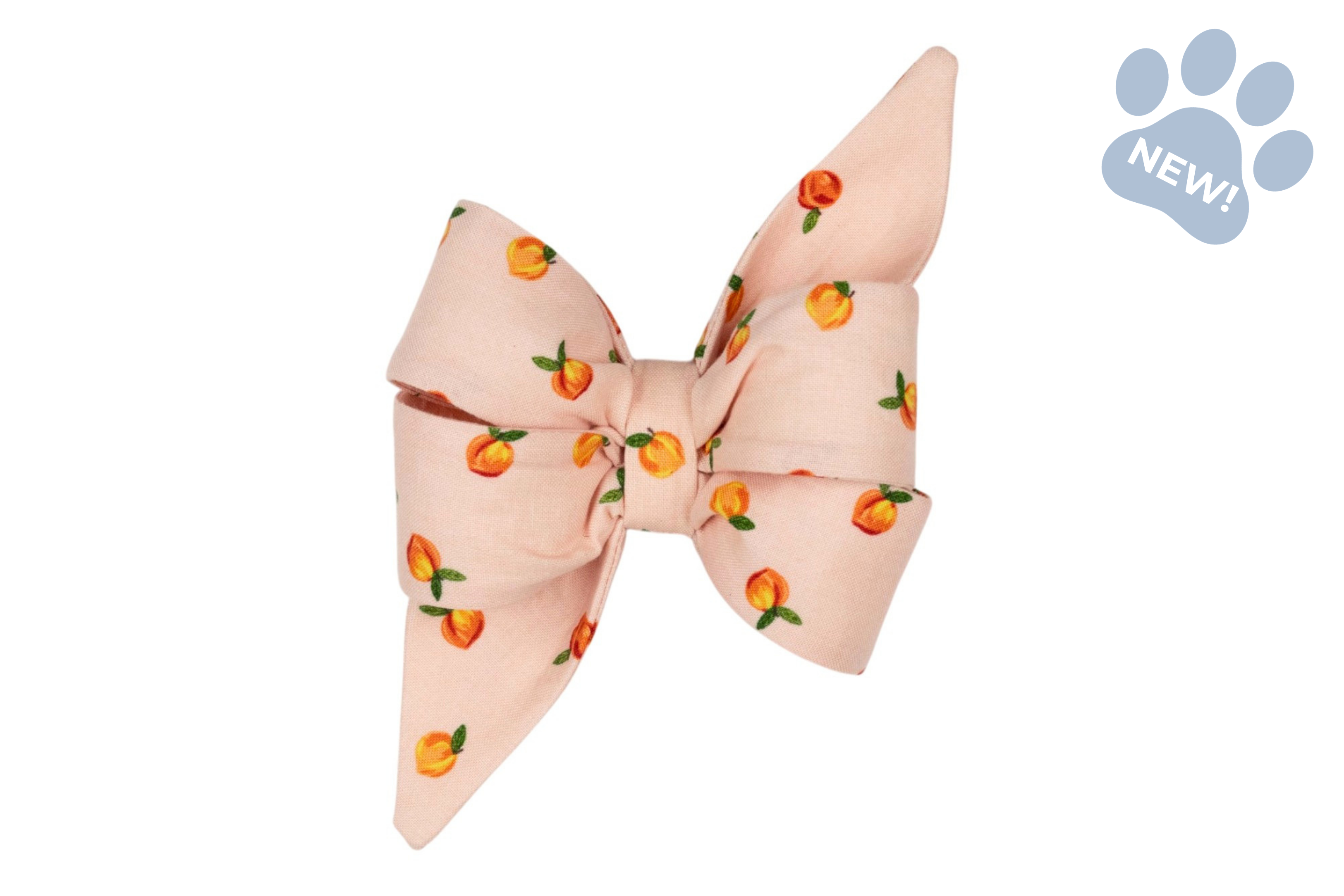Belle bow dog collar accessory in soft blush pink fabric with a scattered peach print, featuring an oversized decorative bow and pointed tails.