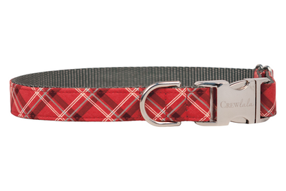 Adjustable dog collar, handmade in Charleston, SC, with a red plaid pattern and metal hardware, including a shiny side-release buckle and D-ring. The interior is made of sturdy webbing for added strength.  