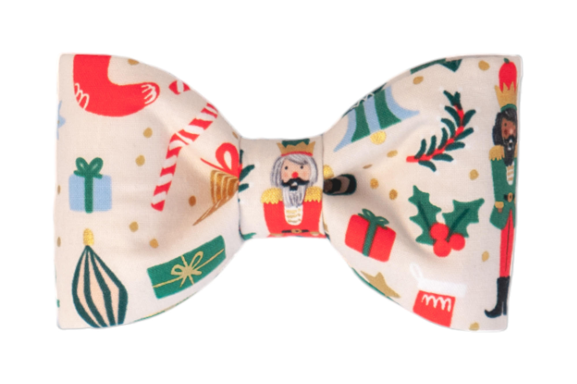Christmas-themed fabric bow tie for dogs, designed with a playful holiday pattern on a cream backdrop. The print includes nutcrackers in festive outfits, holiday stockings, holly sprigs, wrapped gifts, ornaments, and candy canes, accented with small metallic dots.