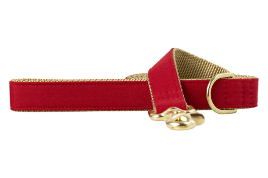 Elegant pet leash showcasing a smooth red fabric on the outside and a woven nylon backing, accented with luxe hardware, including a swivel clip and reinforced stitching near the handle and clasp.