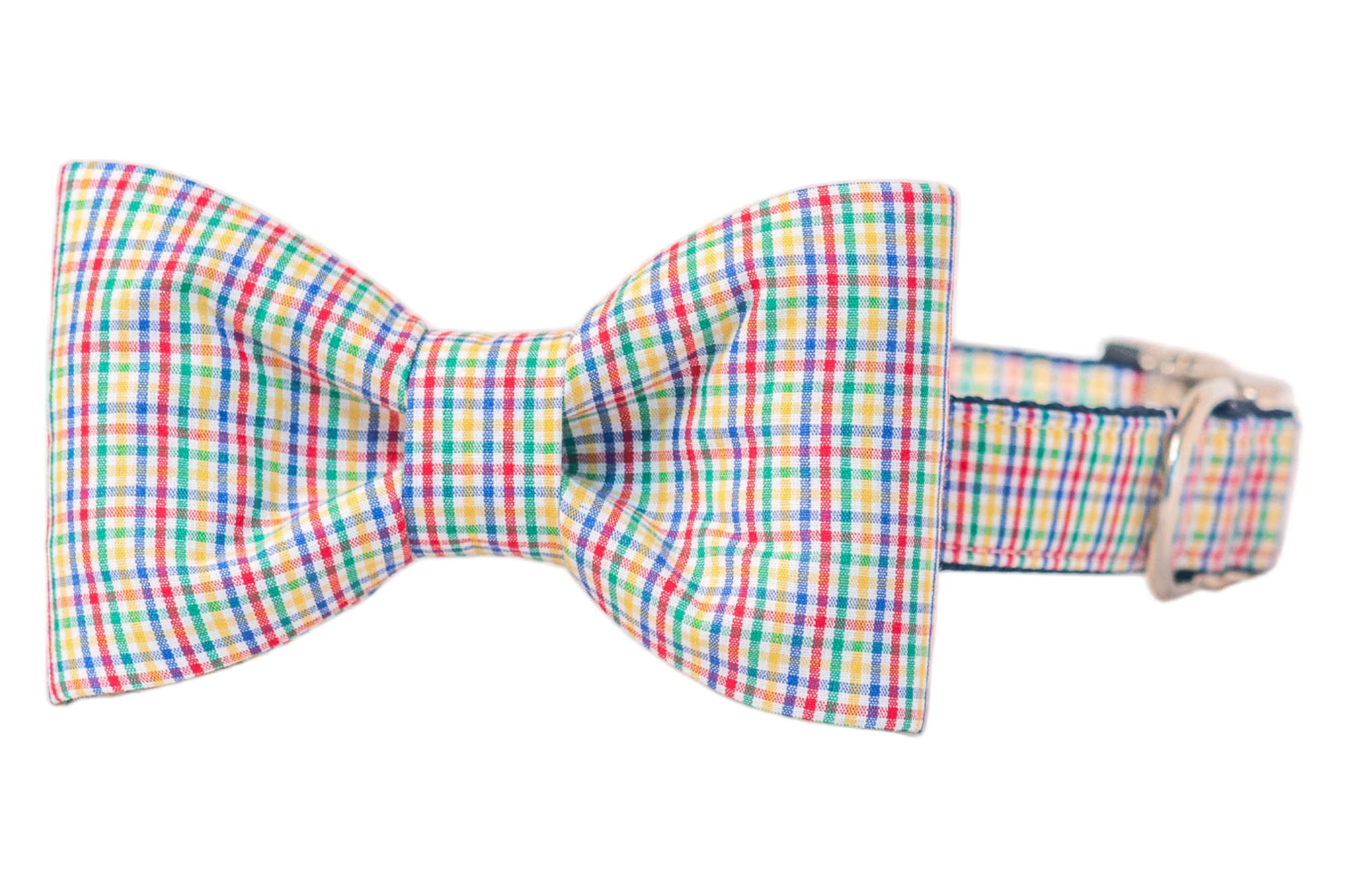 A dog collar with a matching structured bow tie attached, both in a colorful plaid fabric featuring. The bow tie is symmetrical with crisp pleats, and the collar includes a metal buckle and D-ring.