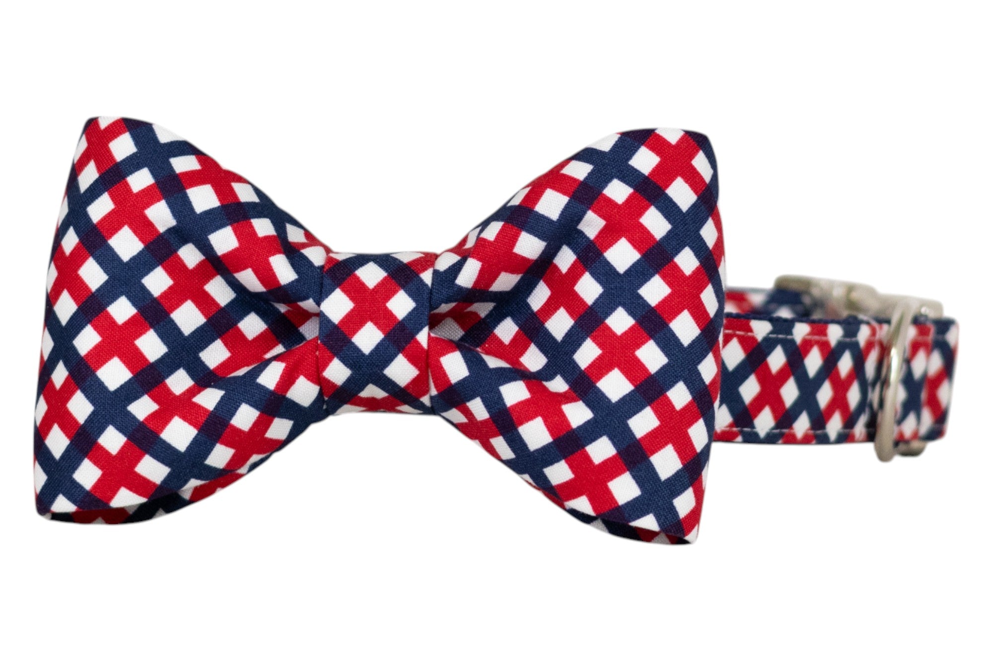 Patriotic-themed dog collar with a decorative bow tie, featuring a red, white, and blue plaid design. The collar includes an adjustable silver buckle for secure fastening.