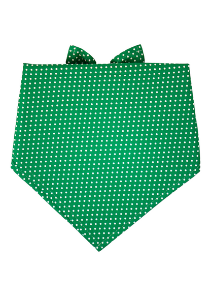 A festive green dog bandana adorned with a dense white polka dot print. Folded in an inverted triangle, the bandana has clean stitched seams and is tied at the top, ready to be worn around a dog's neck.
