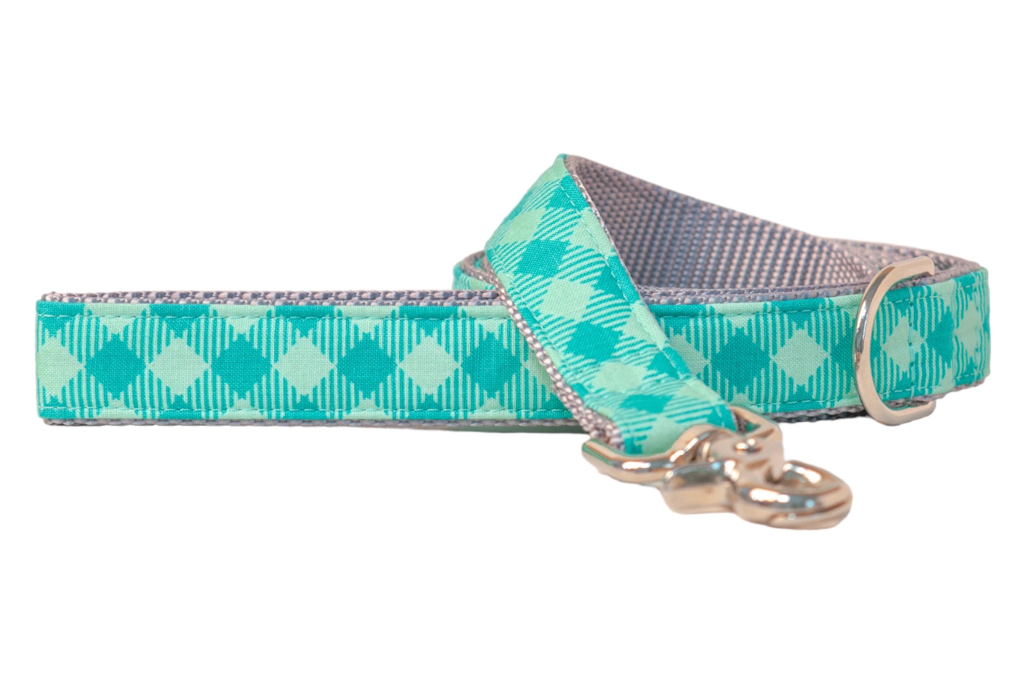 Dog leash in a fresh green plaid pattern with alternating light and dark green diamonds and vertical pinstripes. The leash features a metal D-ring for accessories, and a clasp for attaching to a collar.