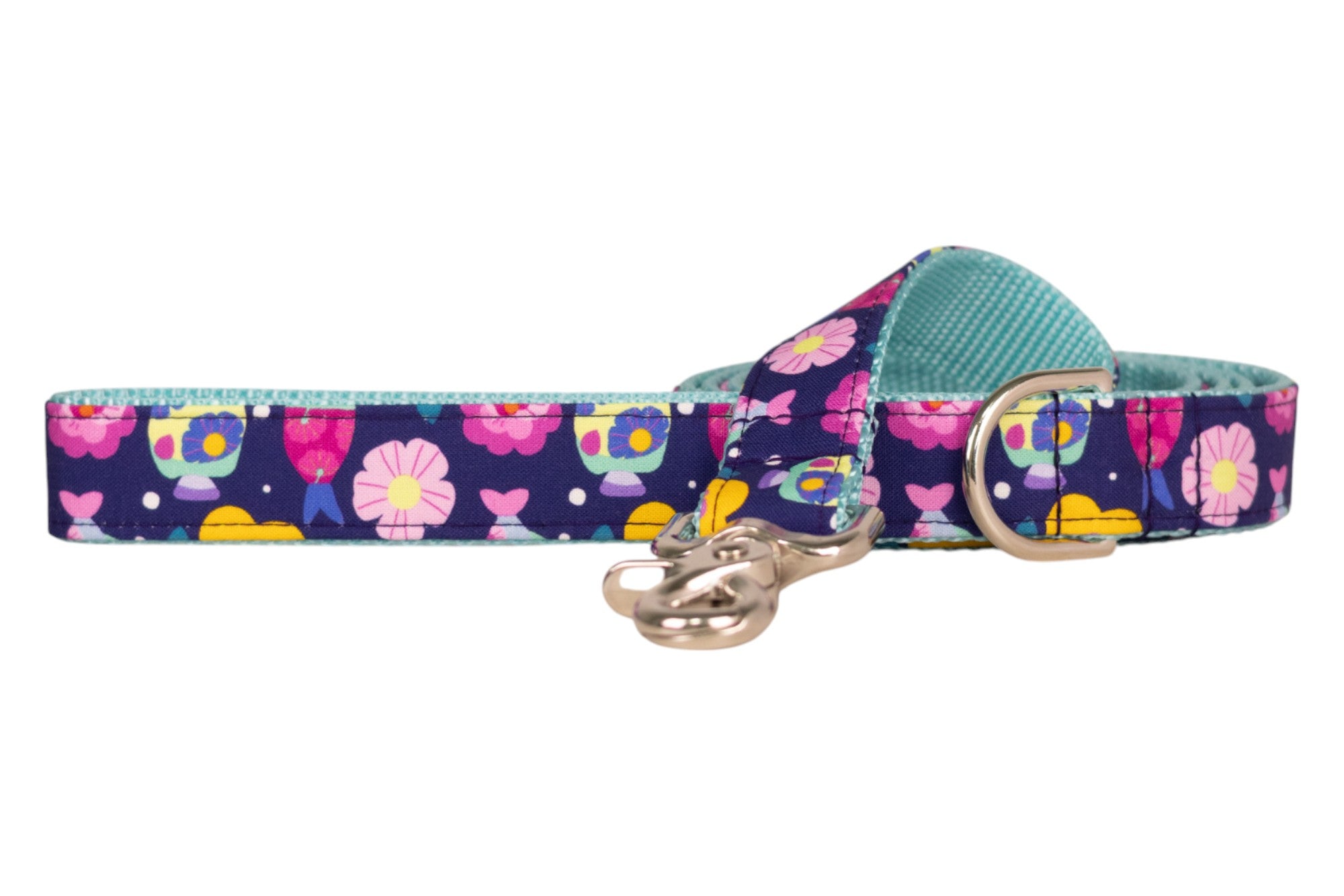  A navy blue dog leash with a colorful print of flowers, fish, and polka dots. The leash is lined with light blue nylon, and features silver-toned hardware, including a metal D-ring and a polished clasp.