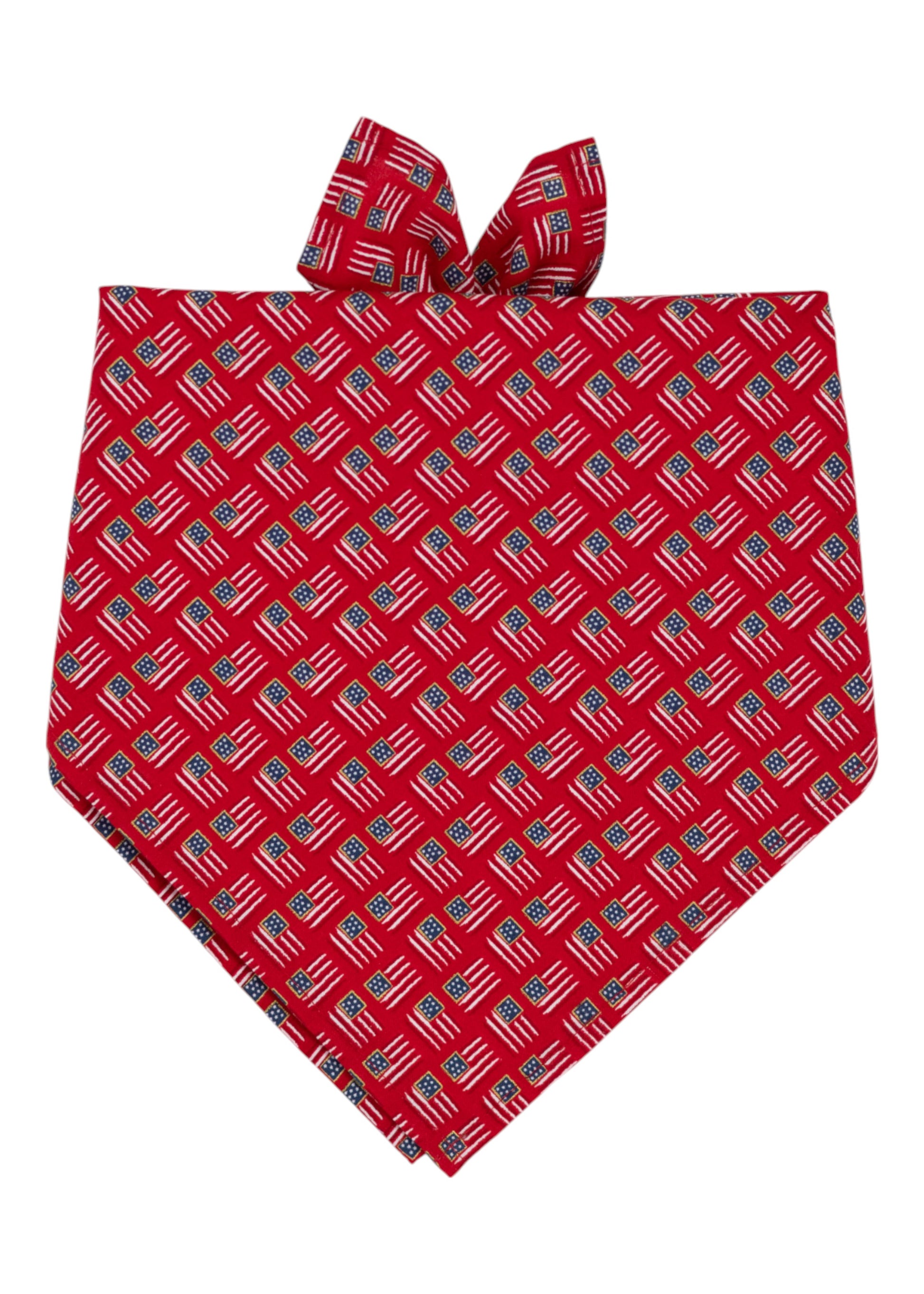 A red Patriotic bandana pet accessory decorated with a repeated pattern of American flags. The bandana is folded into a triangular shape.