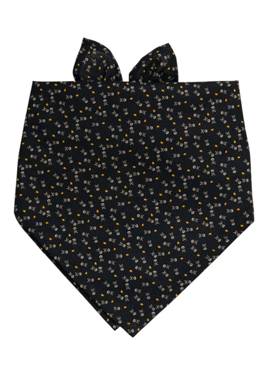 Pirate-themed black fabric bandana for dogs, decorated with miniature skulls, crossbones, and stars, folded in a pointed triangle shape with tie ends at the top.