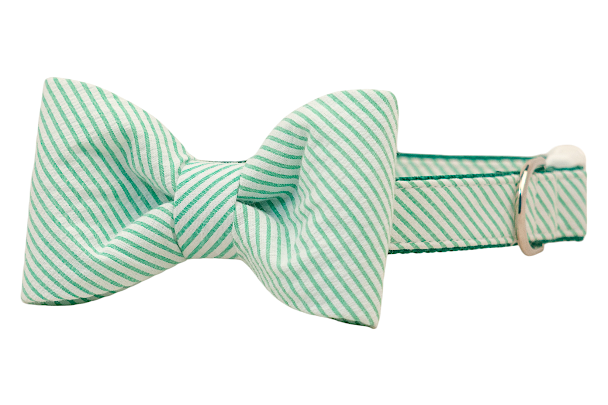 An oversized dog bow tie crafted from green and white seersucker fabric with signature puckered texture. The bow is neatly tied and sits on a matching dog collar, complete with reinforced stitching and a silver buckle.