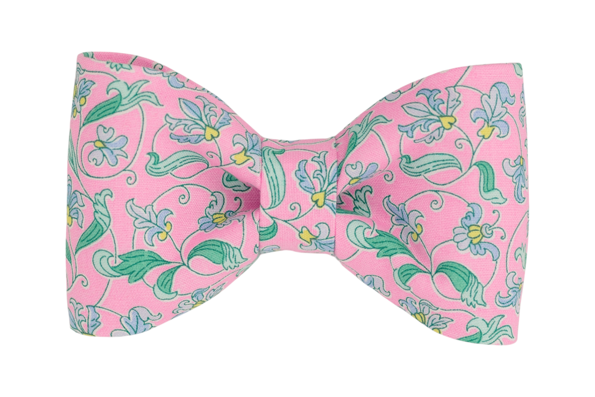 A handmade dog bow tie with an elegant vintage-inspired floral pattern, featuring delicate green vines and pastel blue flowers on a soft pink background. A perfect Spring pet accessory.