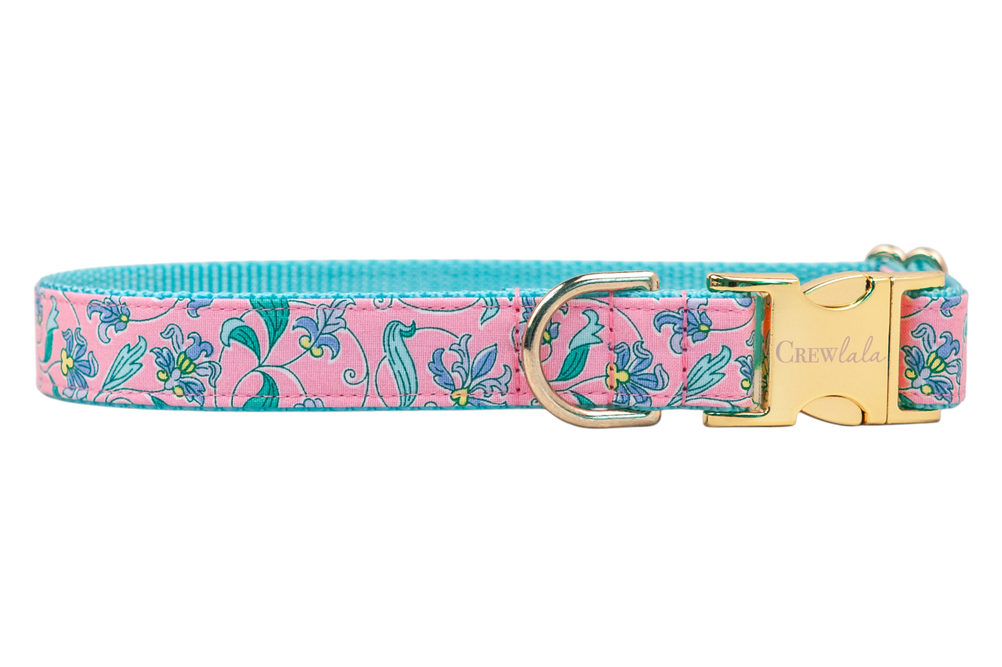 Floral-printed dog collar in blush pink, decorated with graceful green foliage and scattered blue and yellow blossoms. A bright teal backing adds a vibrant touch, while gold-tone hardware, including a D-ring and clasp, brings elegance to the design.
