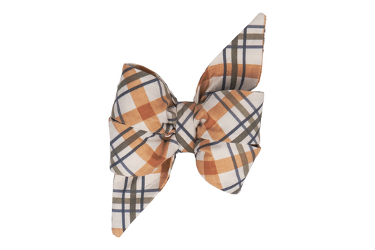A handmade girl dog belle bow with a timeless Fall-inspired plaid design, blending warm hues of orange, beige, and olive green with crisp navy accents.