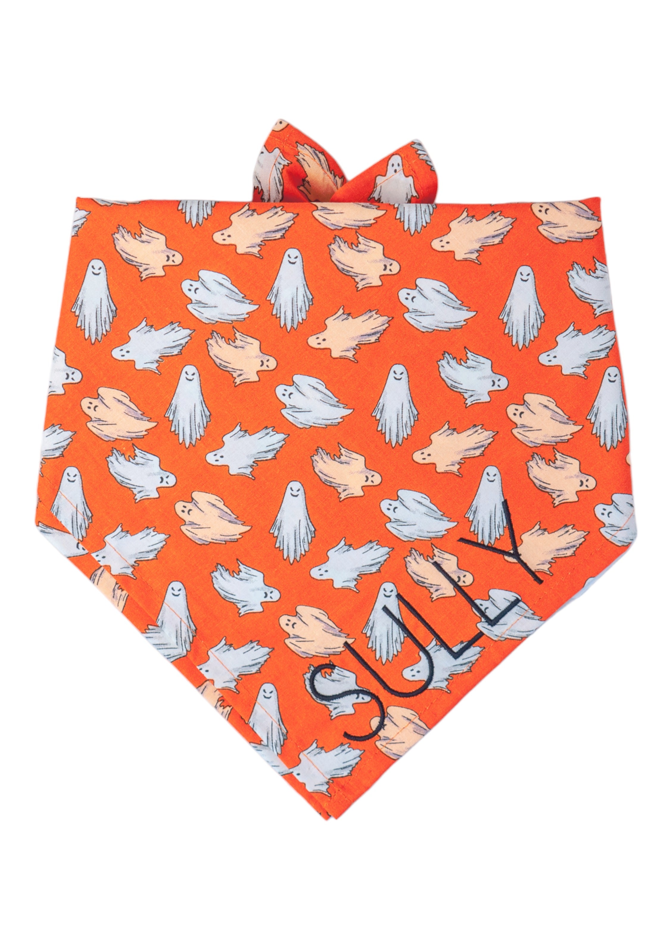 Bright orange Halloween dog bandana covered in scattered cartoon-style ghosts and the name "Sully" embroidered on the right. The ghosts vary in playful floating poses and glow in the dark, making the bandana not only festive but also fun for evening walks. 