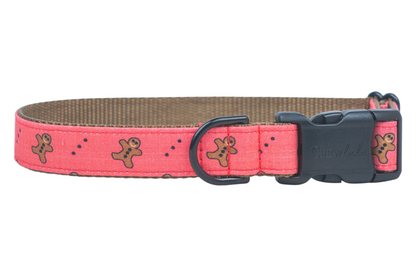 Bring holiday cheer to your pup’s wardrobe with this adorable red dog collar, sprinkled with smiling gingerbread men and playful polka dots—complete with a comfy nylon lining and sturdy hardware for style that lasts all season!
