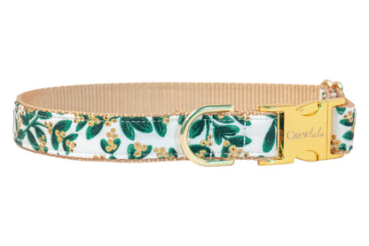Holiday dog collar in a crisp mistletoe print with metallic berry details, featuring polished hardware and a neutral underside for a mix of seasonal flair and classic charm.