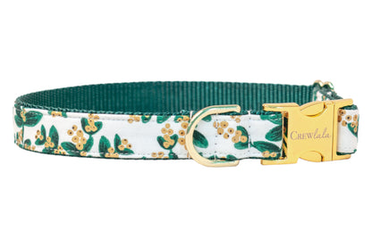 Holiday dog collar in a crisp mistletoe print with metallic berry details, featuring polished hardware and a contrasting underside for a mix of seasonal flair and classic charm.