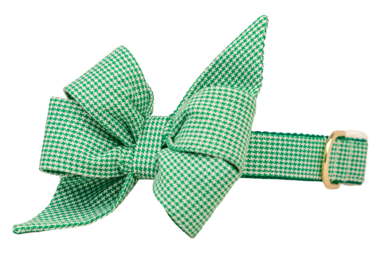 Green houndstooth dog collar with an oversized matching belle bow, featuring pointed ends that extend outward for a stylish look. The collar includes a metal D-ring and a side-release buckle, with the belle bow crafted from the same fabric for a coordinated design.