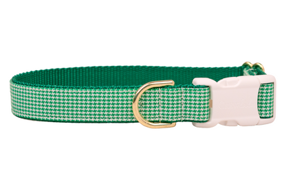 Stylish dog collar in a green houndstooth pattern, complemented by a green underside, metal hardware, and a plastic buckle for easy fastening and adjustment.