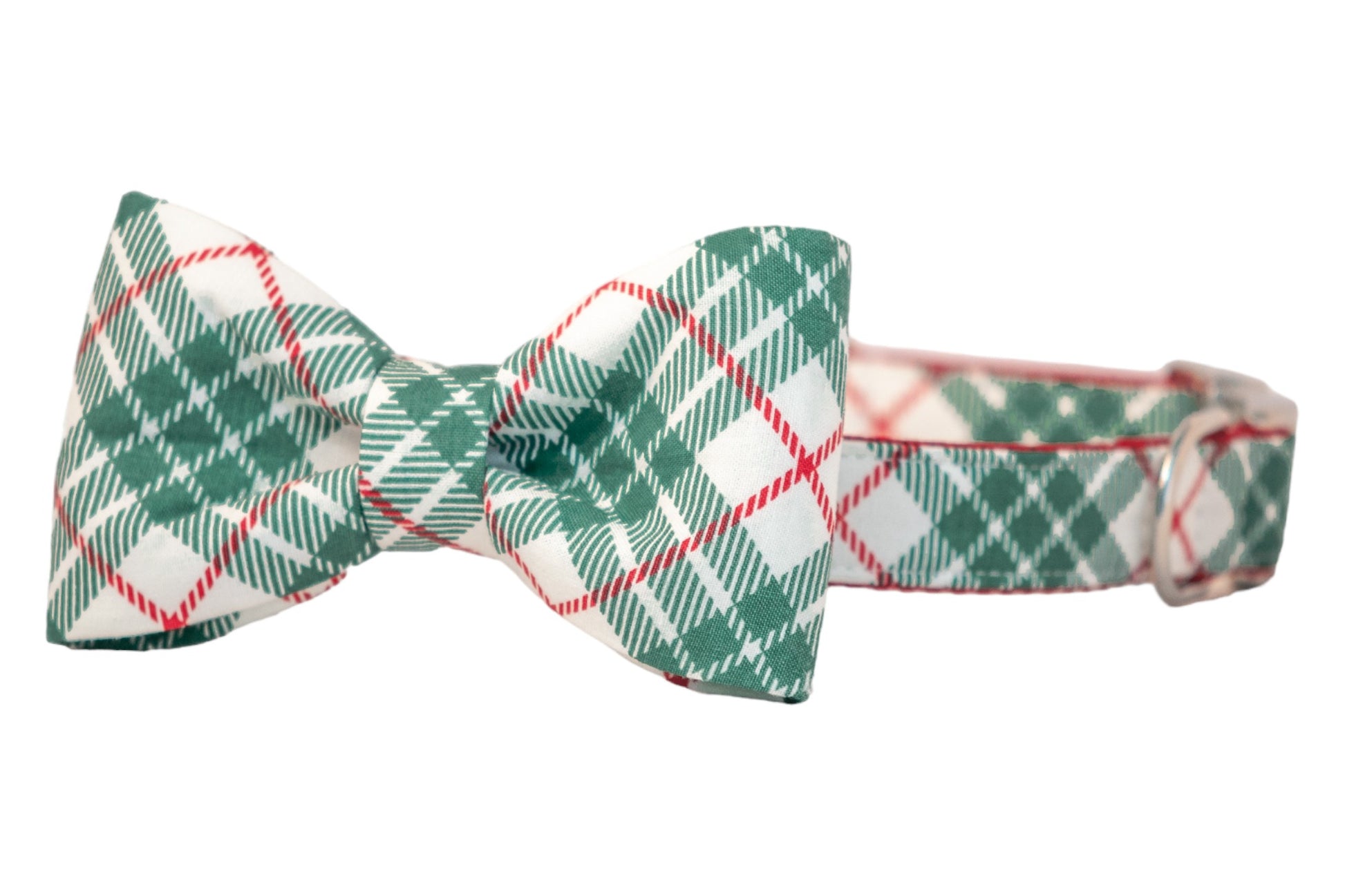A festive dog collar featuring an attached matching bow tie with a green plaid pattern on a light fabric background. The bow tie is neatly tied in a classic symmetrical shape, and the collar includes  metal hardware for adjustment.