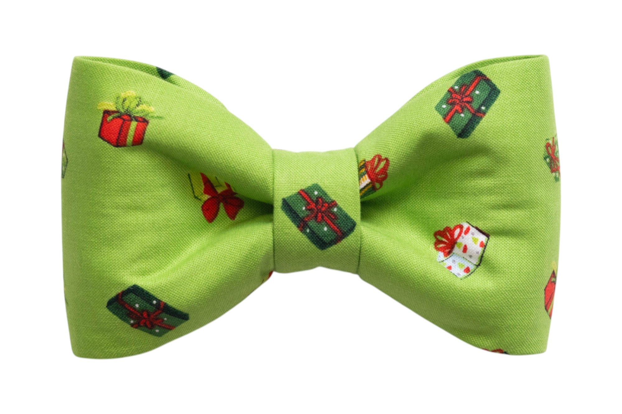 Classic bow tie for dogs in green fabric with a playful gift box pattern featuring festive ribbons and colorful wrapping. The symmetrical bow tie design is crisp and compact, ideal for attaching to a collar during the holiday season.