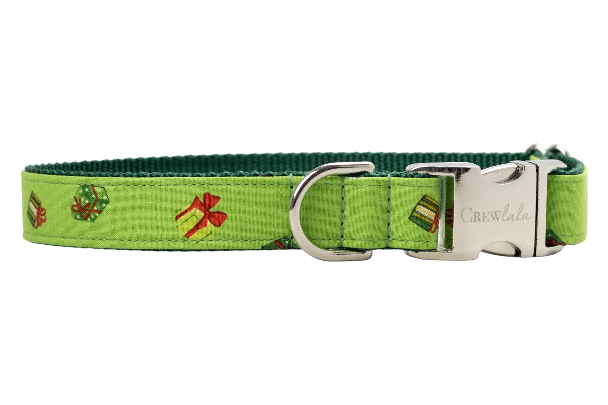 Festive dog collar made from bright green fabric printed with small colorful gift boxes in festive colors, each tied with decorative bows. The collar features dark green woven backing for durability and metal hardware, including a branded “Crewlala” buckle.