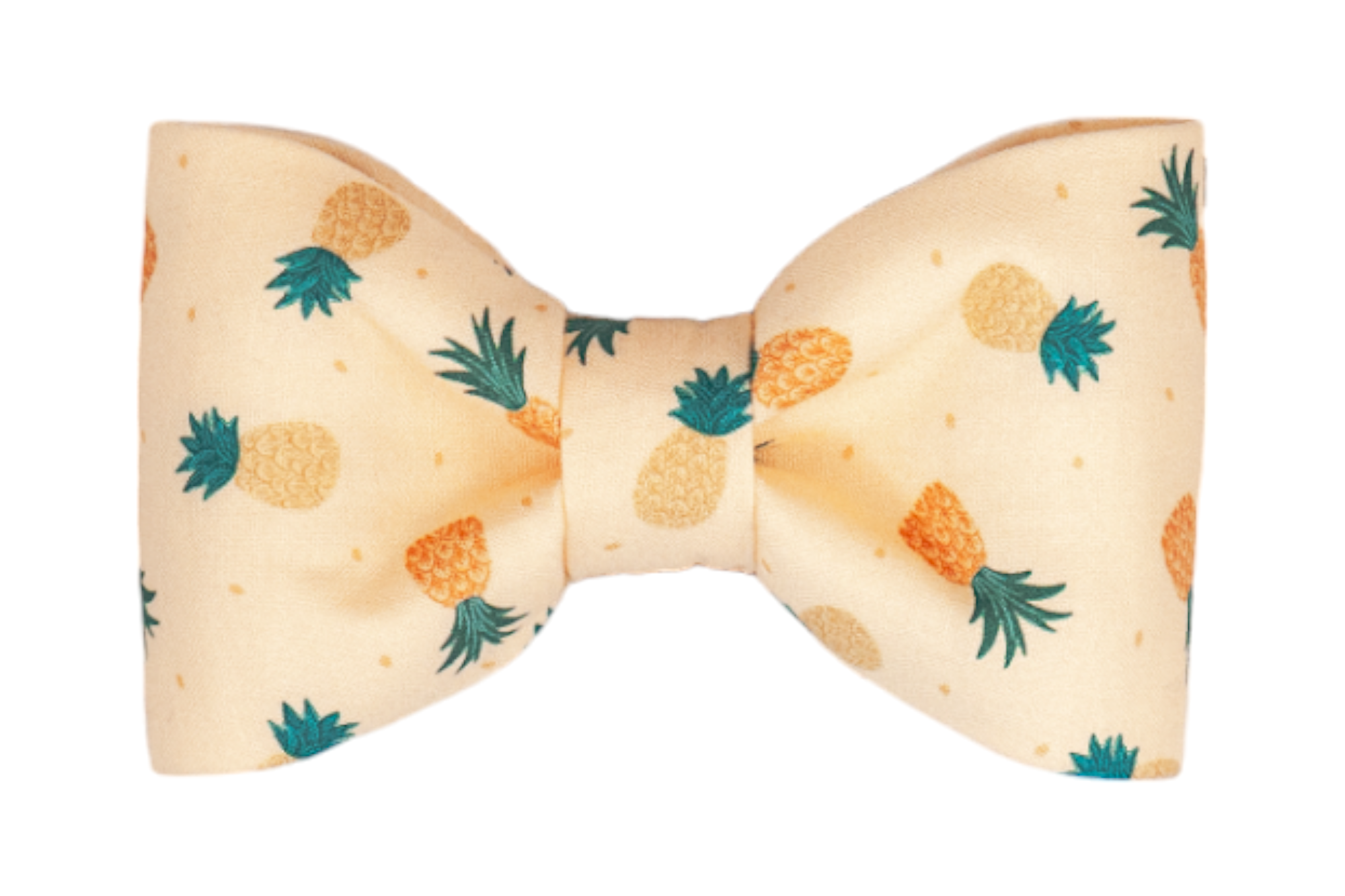 A symmetrical dog bow tie made from light beige fabric, decorated with a repeating pattern of small pineapples in shades of yellow and orange with green leafy tops. The bow is neatly cinched at the center and has a playful, tropical feel.