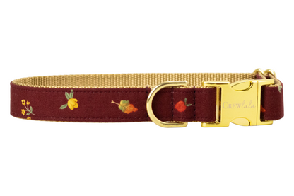 Burgundy dog collar adorned with tiny fall leaves and florals, complete with a metal buckle engraved with "Crewlala" and matching D-ring.