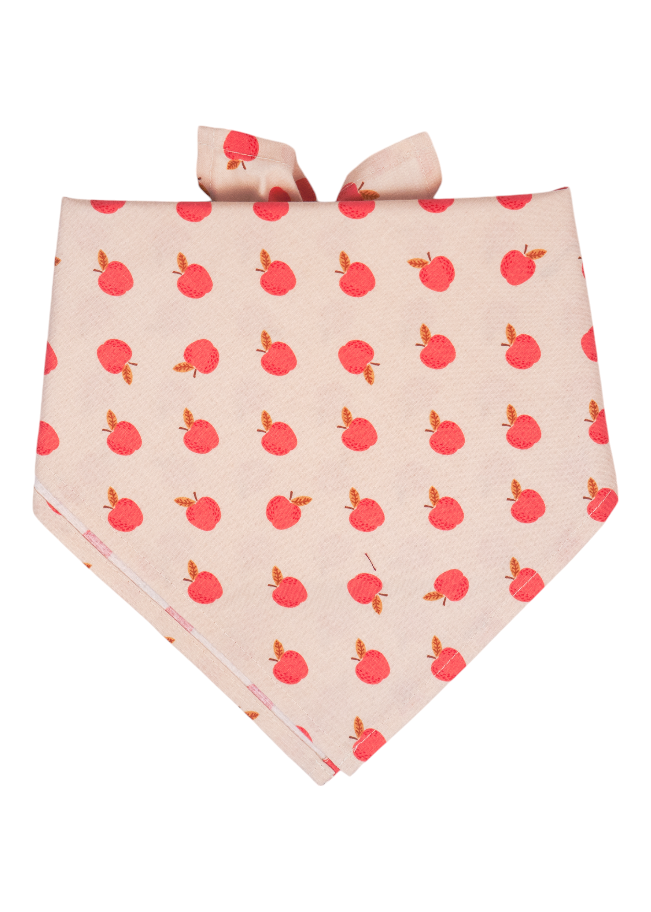 A cream-colored dog bandana with an all-over print of small red apples with leaves, folded into a triangle shape and tied at the top. Handmade in Charleston, SC.