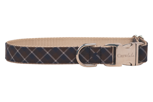 Classic dog collar featuring a navy and brown diamond plaid print, nylon interior webbing, silver D-ring, and engraved buckle.
