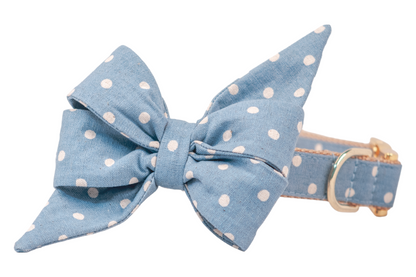 Chic and playful dog collar in soft blue with a whimsical ivory white polka dot pattern and a large matching belle bow that includes long, pointed ends, secured with shiny gold hardware.