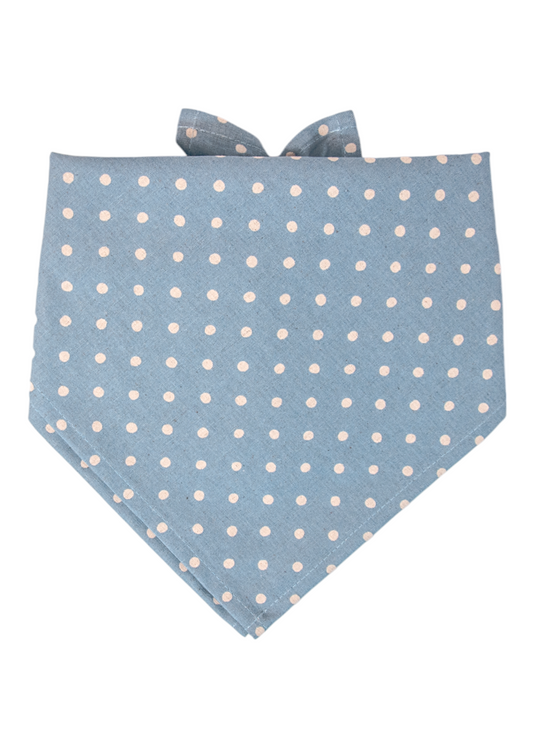 Soft blue fabric dog bandana covered in evenly spaced ivory white polka dots, tied in a tidy knot at the back with crisp pointed corners for a playful, preppy look.