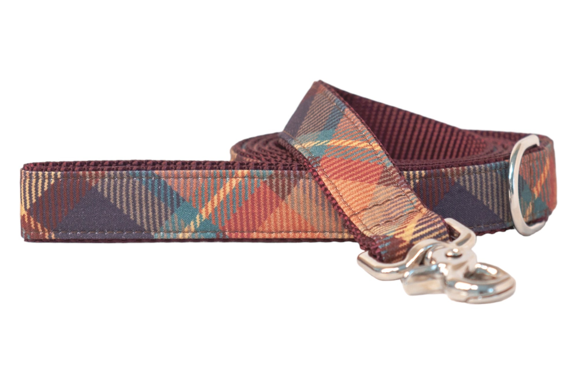 Dog leash with a rich plaid fabric design in fall-inspired colors, finished with sturdy stitching and a shiny swivel snap hook.