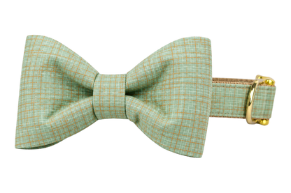 Classic dog collar featuring a Jadeite Green fabric bow tie, a soft jadeite mint green linen with a fine tonal plaid weave, attached to a matching Jadeite Green collar with a nylon inner lining and gleaming gold hardware, including a D-ring and buckle.