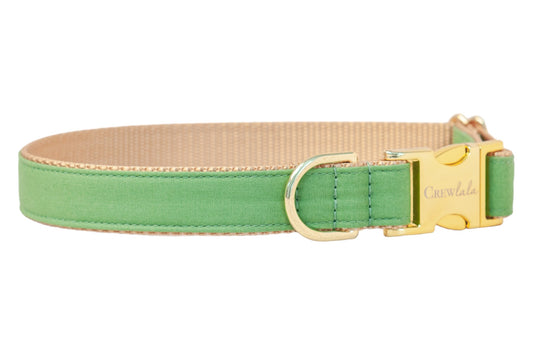 A solid laurel green dog collar with a tan webbed interior and gold-tone hardware. The collar features a shiny gold side-release buckle engraved with the brand name "Crewlala" and a matching D-ring for leash attachment