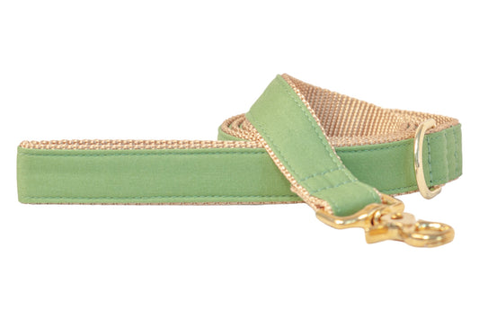 A laurel green dog leash with a tan woven underside and sturdy gold-tone metal hardware. The leash features reinforced stitching and a polished gold clasp for secure attachment, combining durability with a soft, natural color palette.