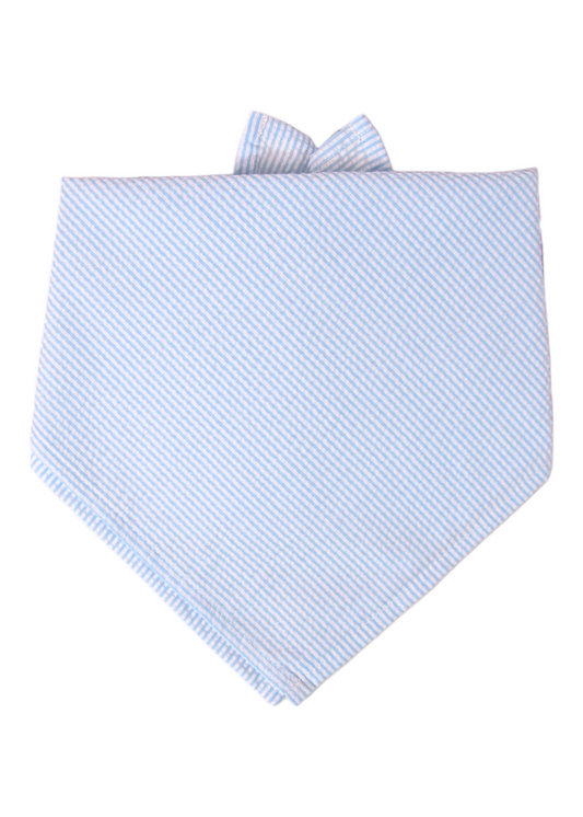 Neatly folded blue and white striped seersucker bandana in a tie-on triangle style. The diagonal stripes give a clean, tailored look, and the small visible knot at the top shows how it would be worn around a pet’s neck. The simple pattern adds a classic, southern flair.