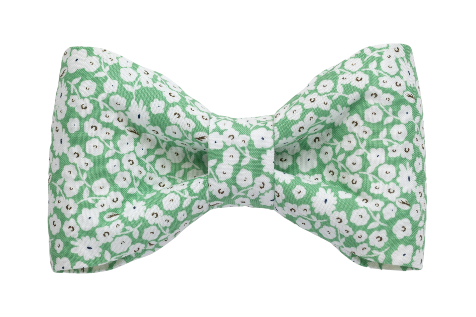 Handcrafted floral bow tie for dogs, showcasing a soft green canvas sprinkled with petite white blooms.