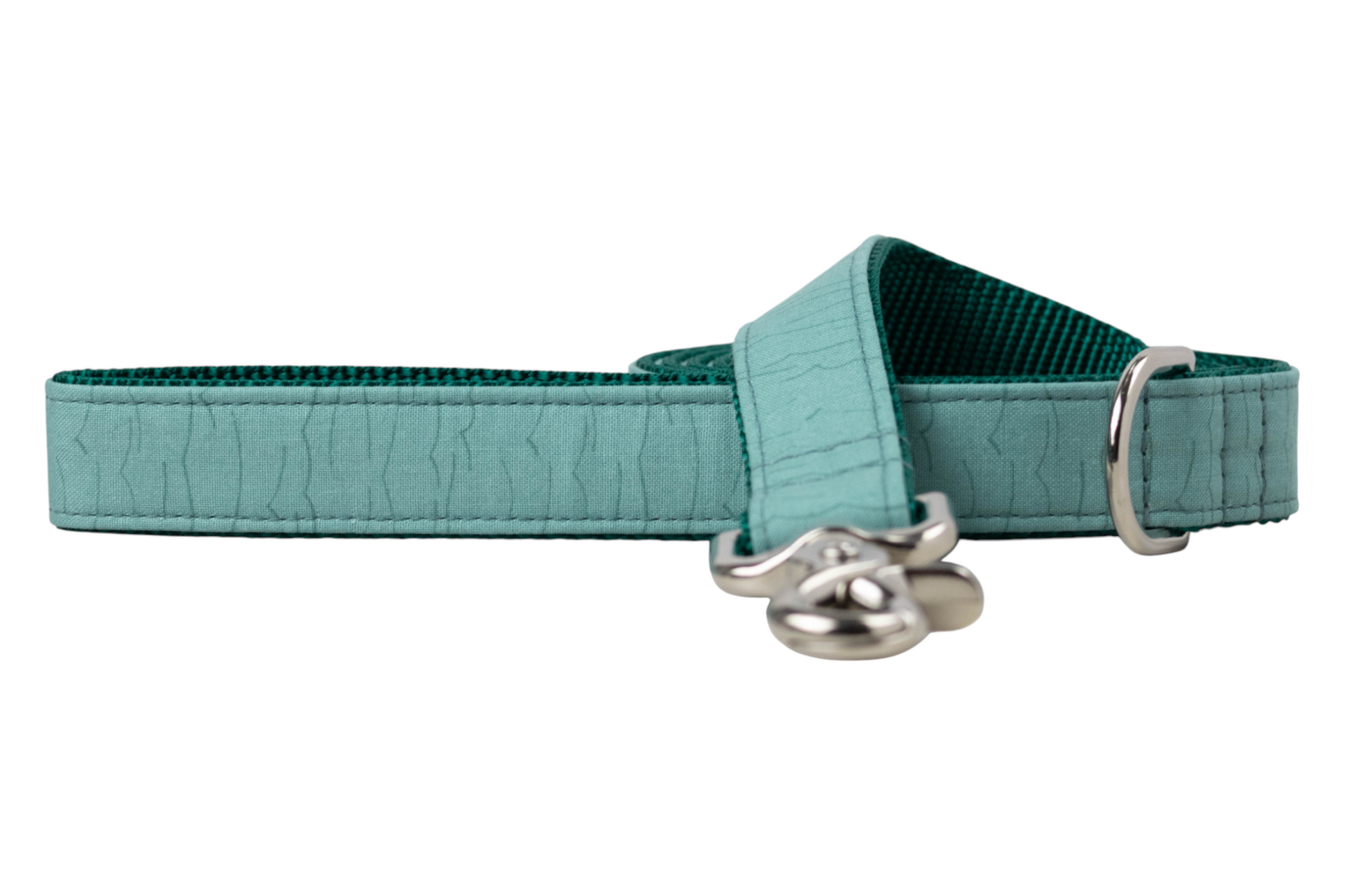 Minimalist teal dog leash featuring a rippled wave texture on the outer fabric, deep teal webbing on the inner side, and silver-tone metal fittings