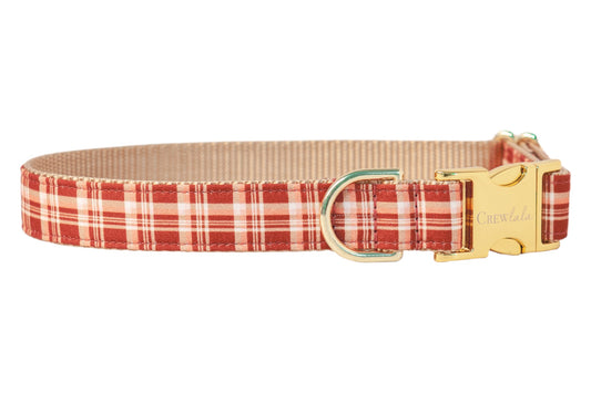 Classic red plaid dog collar with a nylon backing and polished hardware, including a side-release buckle. Perfect for a fall stroll!