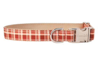 Classic red plaid dog collar with a nylon backing and polished hardware, including a side-release buckle. Perfect for a fall stroll!