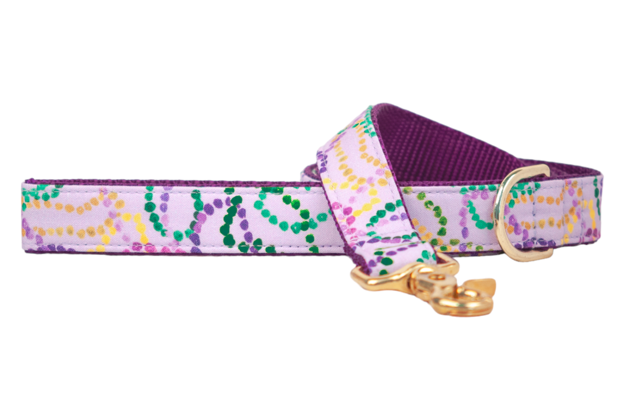 Vibrant dog leash featuring swirling Mardi Gras beads in traditional colors on a pastel purple base, accented with rich purple webbing and shiny clip hardware.